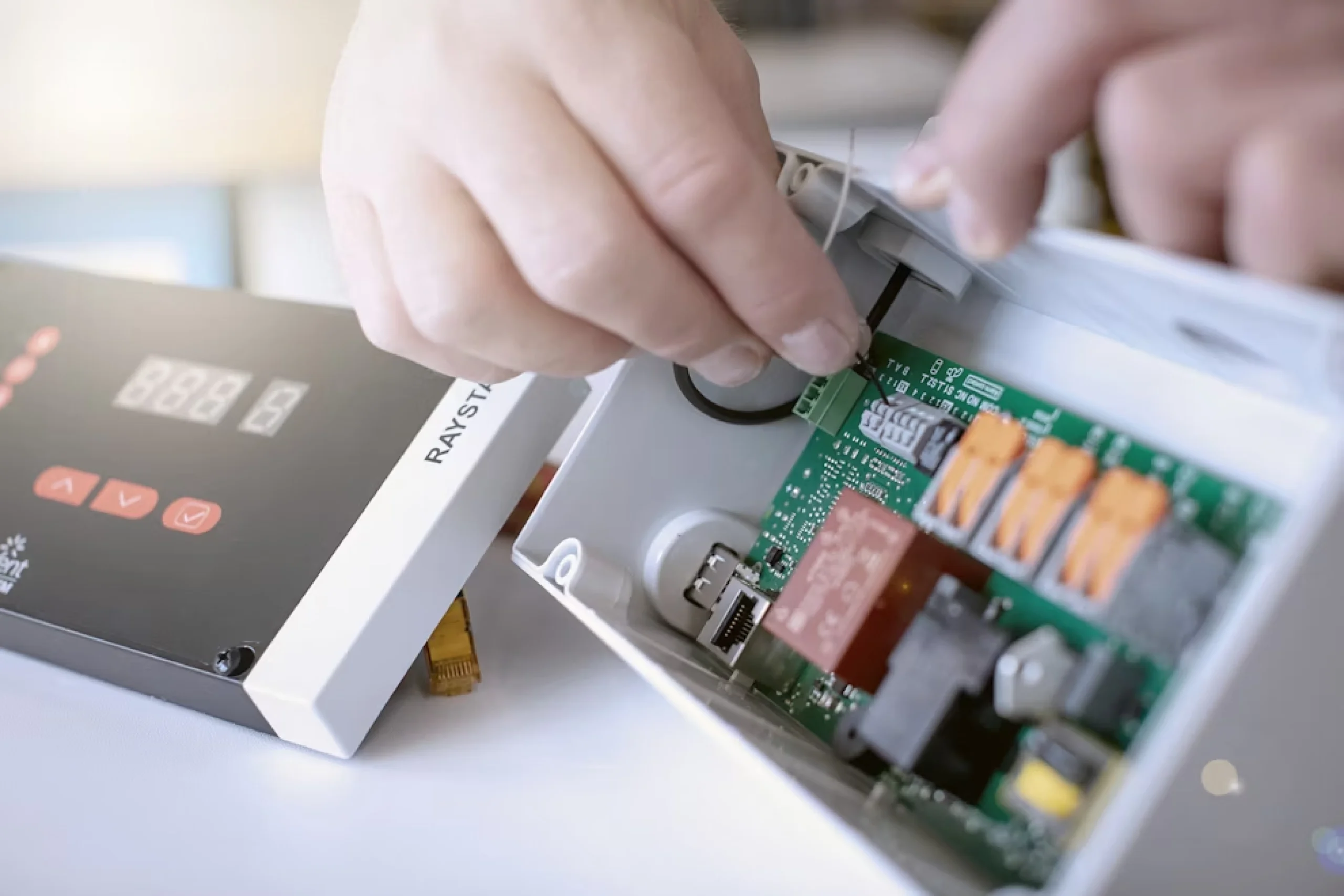 Eine Person bastelt an einer elektrisch aussehenden Platte